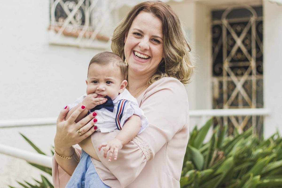 Heitor's mother laughing during the baptism day