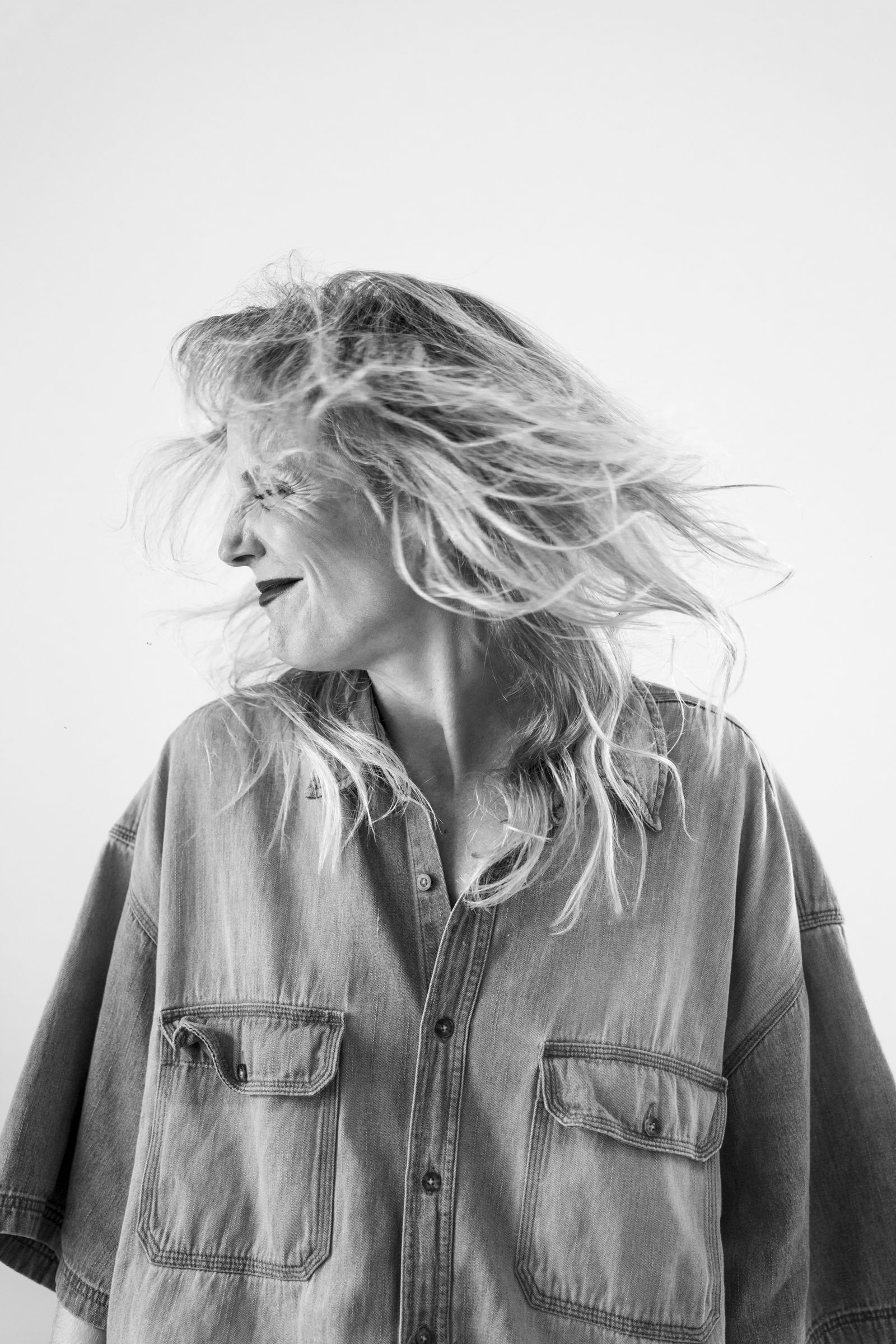 Mireia laughing with her hair caught in the wind